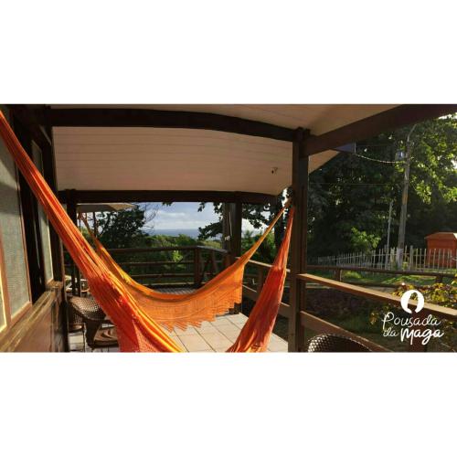 a hammock on a porch of a house at Pousada da Maga in Fernando de Noronha