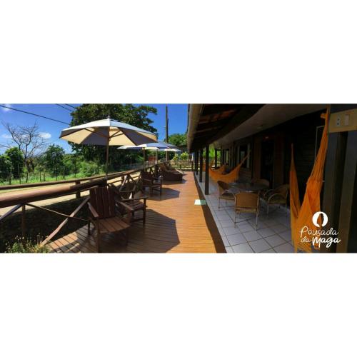 a patio with tables and chairs and umbrellas at Pousada da Maga in Fernando de Noronha