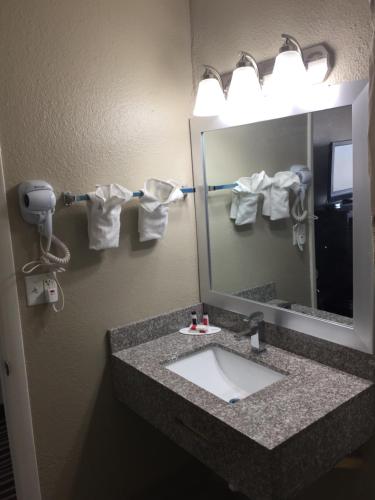 a bathroom with a sink and a mirror at Super 8 by Wyndham Florence in Florence