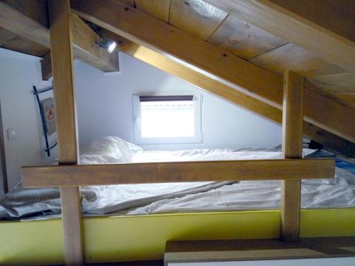 a bunk bed in a room with a window at Tiny house with a big heart in Postojna