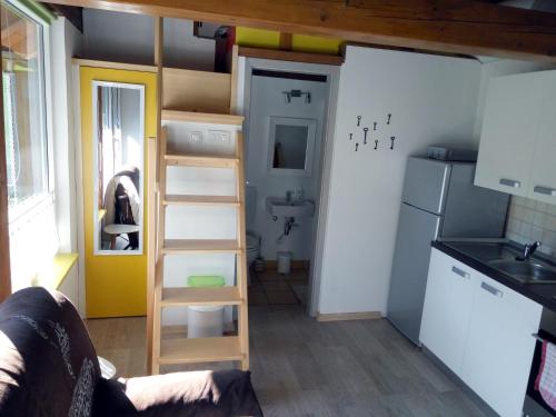 a small kitchen with a ladder in a tiny house at Tiny house with a big heart in Postojna