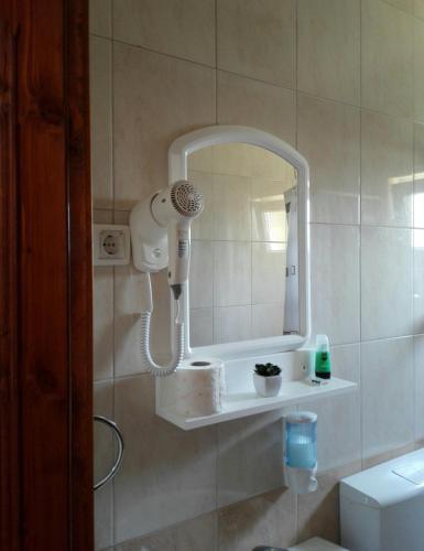 a bathroom with a blow dryer and a mirror at Sobe BCRNJAC in Međugorje