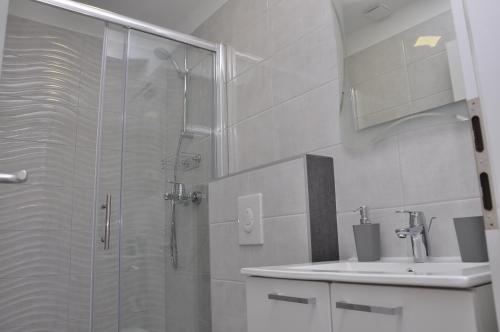 a bathroom with a shower and a sink at Rooms Ive in Lozovac