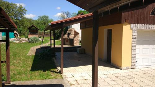 a garage with a white door and a building at Holiday Home Mia in Belá