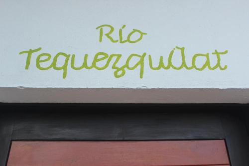a sign on top of a building with the words rio restaurant at Hotel Boutique La Casona de Don Porfirio in Jonotla