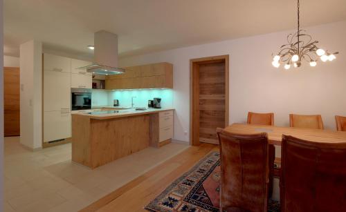 a kitchen and dining room with a wooden table at Appartements Kirchenwirt in Kirchberg in Tirol