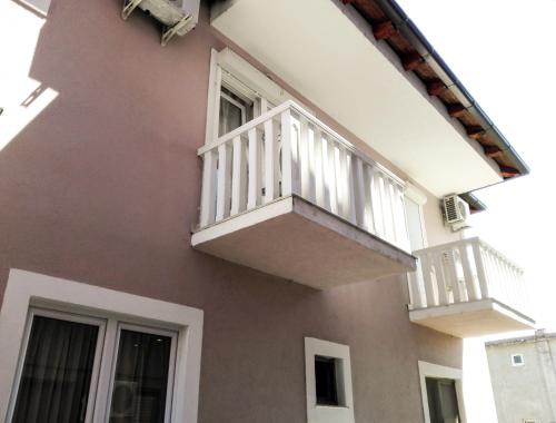 a building with two balconies on the side of it at Sobe BCRNJAC in Međugorje