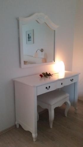 a white dressing table with a mirror and a light at Country Dream - Langholt 2 in Selfoss
