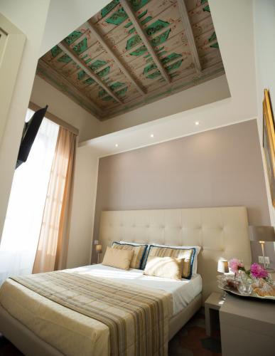 a bedroom with a large bed and a window at Antico Angelo - Residenza d'Epoca in Viterbo
