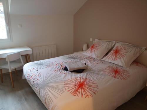 a bedroom with a bed with umbrellas on it at Cottage nuiton in Nuits-Saint-Georges