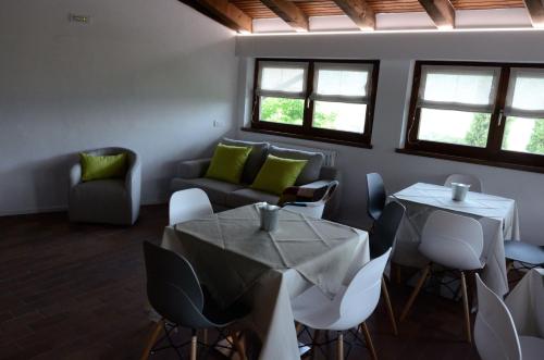 a living room with tables and chairs and a couch at Al Trifoglio in Campodenno