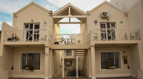 a large white house with two balconies on it at Edymar in Puerto Madryn