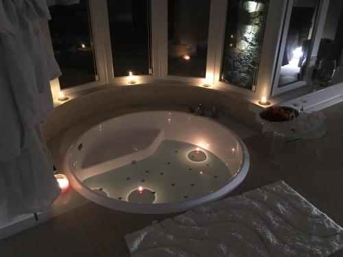 a bath tub with lights in a bathroom at Suite Amnesia in Mesagne