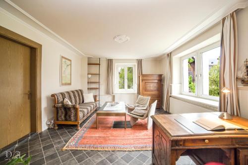 a living room with a couch and a table at Ferienwohnung für zwei Personen mit Küche in Triesen