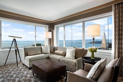 a living room with a couch and a large window at Fairmont San Francisco in San Francisco