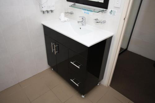 a bathroom with a black and white sink at Picton Valley Motel Australia in Picton