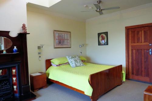 a bedroom with a bed and a wooden door at McCloud House in Port Noarlunga