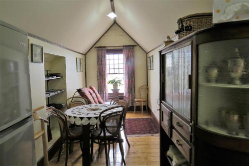 a dining room with a table and some chairs at McCloud House in Port Noarlunga