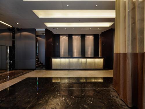 a lobby of a hotel with a stage and lights at The Tango Hotel Taipei XinYi in Taipei