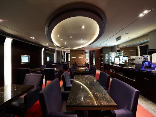 a restaurant with tables and chairs and a large orb at The Tango Hotel Taipei XinYi in Taipei