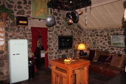 a living room with a refrigerator and a table in it at Clenaghans in Moira