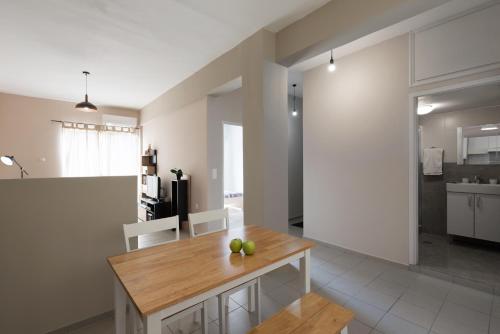 a kitchen and living room with a wooden table at Central Luxury Apartment in Rethymno