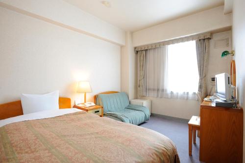 Кровать или кровати в номере Shibetsu Grand Hotel