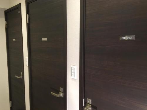 a row of wooden doors in a building at TIMES INN 2F in Tokyo