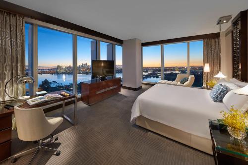 a bedroom with a large bed and a desk with a television at Crown Towers Perth in Perth