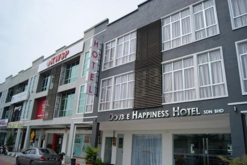 a building with a sign on the front of it at Double Happiness Hotel in Seri Manjung