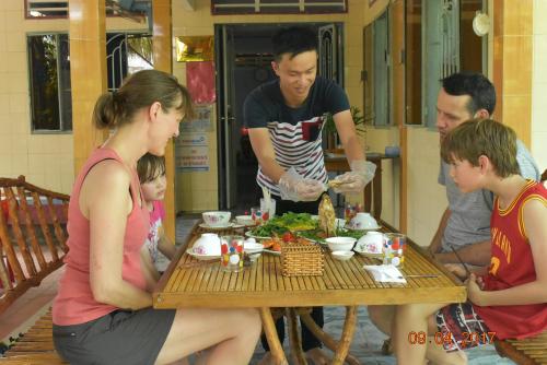 a group of people sitting around a table eating food at Mekong Rustic Cai Be in Cai Be