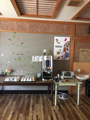 an office with a desk with a computer on a wall at Hotel Hirayunomori Annex in Takayama