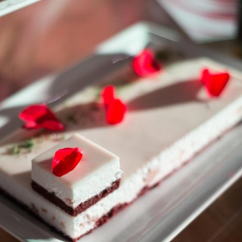 a piece of cake with red roses on a plate at Novotel Lucknow Gomti Nagar in Lucknow