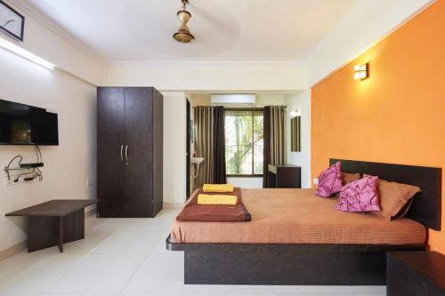 a bedroom with a large bed in a room at Sea Land Kihim in Alibaug
