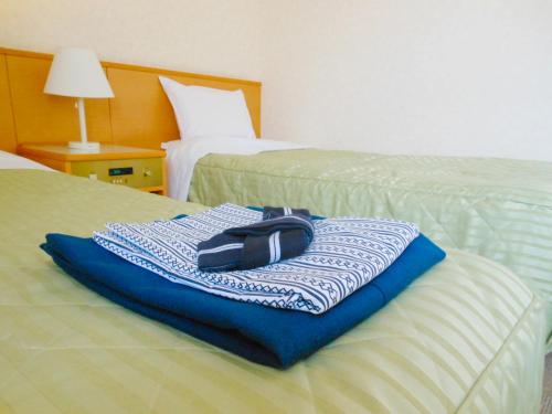 a bag sitting on top of a bed in a hotel room at Shibetsu Grand Hotel in Shibetsu City