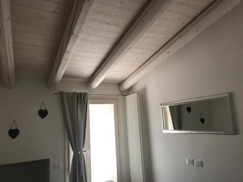 a room with a ceiling with a window and a curtain at Antonella Gardalake 2 in Desenzano del Garda