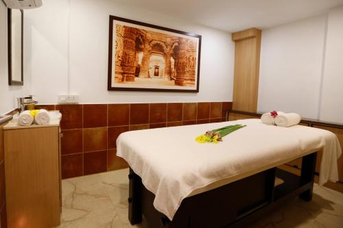 a hospital room with a bed with flowers on it at Zone By The Park, ORR, Chennai in Chennai