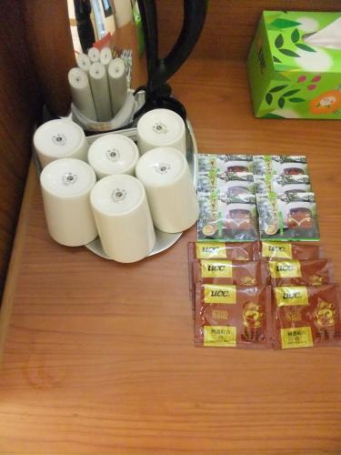 a table with several rolls of toilet paper and packets of candy at Nice Hotel in Kaohsiung