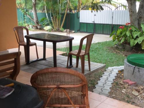 a table and two chairs and a table and chairs at Galappathie Residence in Tangalle