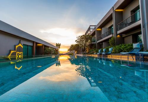 a large swimming pool in front of a hotel at Fusion Suites Phuket Patong in Patong Beach