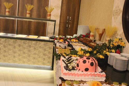 a table with a cake with a lady bug on it at Ayder Hasimoglu Hotel in Ayder Yaylasi