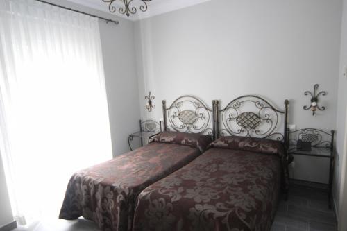 Ένα ή περισσότερα κρεβάτια σε δωμάτιο στο Hostal Roma