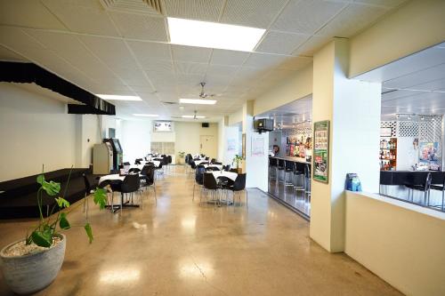 a room with chairs and tables in a store at Commercial Hotel in Charters Towers