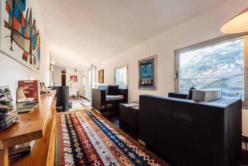 a living room filled with furniture and a large window at Penthouse Le Terrazze Duomo view in Florence