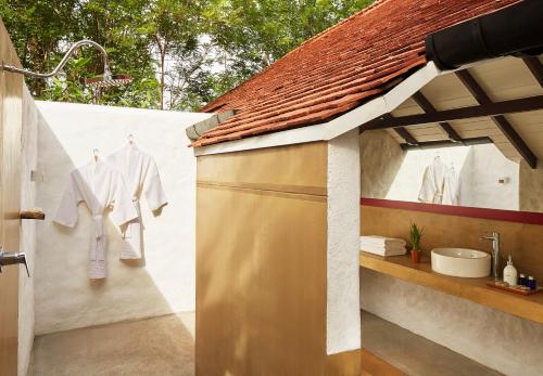 a bathroom with a shower and a sink at Jetwing Kaduruketha in Wellawaya