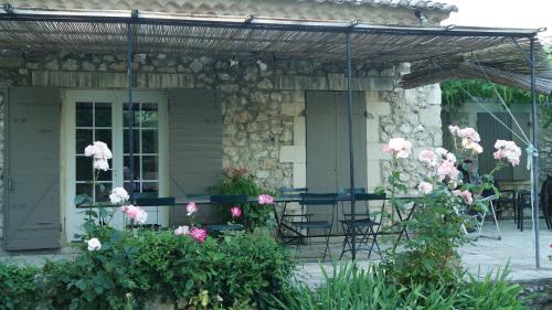 a house with a porch with chairs and flowers at Mas Grimaud - Gîte- Studio et chambres d'hôtes familiales in Eygalières