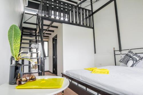 a room with two beds and a table with a yellow tray at The Marian Boutique Lodging House in Kuching