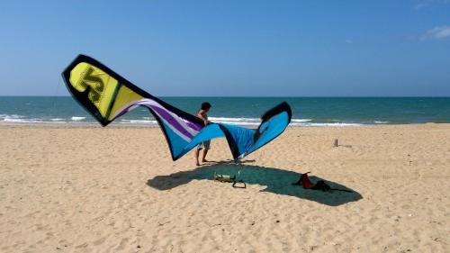 a person holding a large kite on the beach at Wellé Wadiya Beach Villa in Kalpitiya