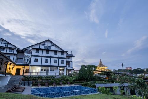 a large building with a clock on top of it at The Marian Boutique Lodging House in Kuching