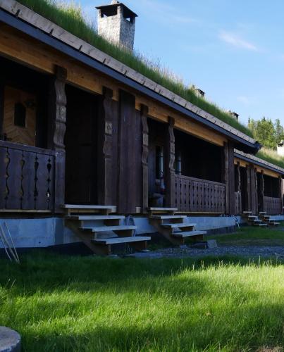 an old building with steps in front of it at Rondane Hytter og Leiligheter in Otta
